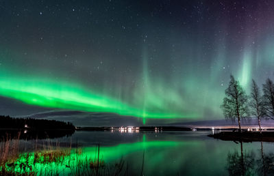 Scenic view of lake against sky at night