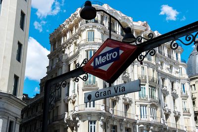 Low angle view of road sign against sky