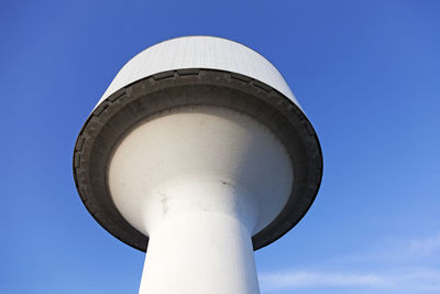 Low angle view of water tower against blue sky