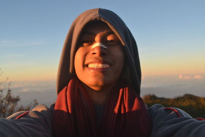 Portrait of smiling man against sky during sunset