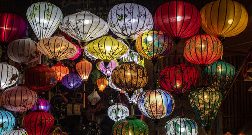 Low angle view of illuminated lanterns hanging at night