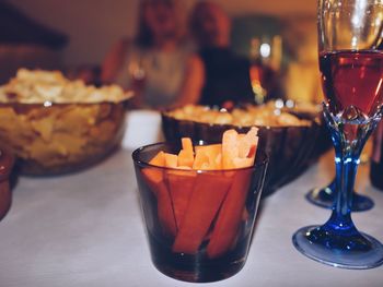 Close-up of french fries with cocktail glass on table at restaurant
