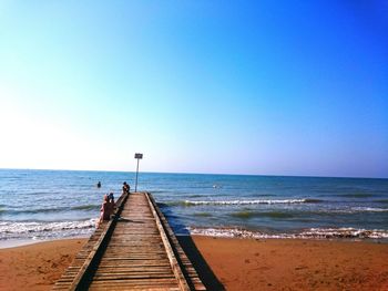 Scenic view of sea against clear blue sky