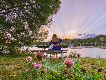 Rear view of woman sitting on field