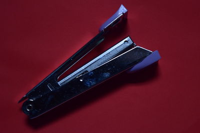 High angle view of telephone on table against red background