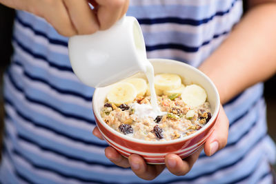 Midsection of woman holding food