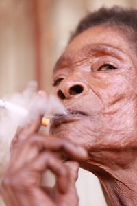 Close-up of senior woman smoking