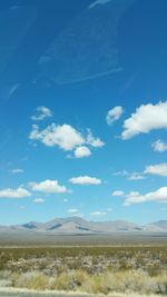 Scenic view of mountains against cloudy sky