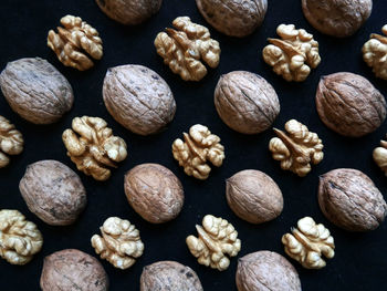 Full frame shot of walnuts over black background