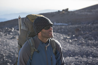 Portrait of man wearing hat on land