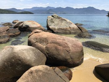 Rocks on sea shore against sky on ilha grande rio de janeiro 