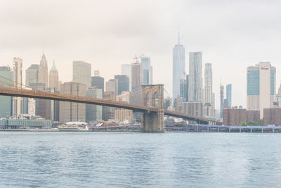 View of the famous brooklyn bridge and new york skyline from brookyn bridge park,during a foggy day