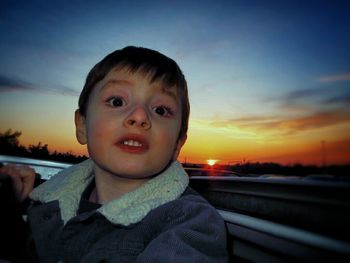 Portrait of boy with arms raised