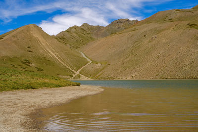 Scenic view of lake and mountains against sky