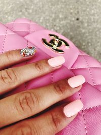 Close-up of woman hand holding pink flowers