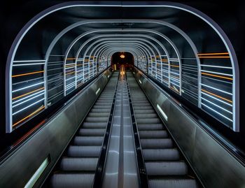 Rear view of man on illuminated tunnel