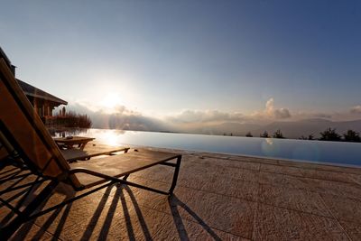 Scenic view of swimming pool by sea against sky