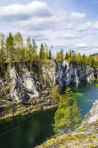 Scenic view of river and mountains against sky