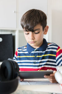 Portrait of boy holding mobile phone