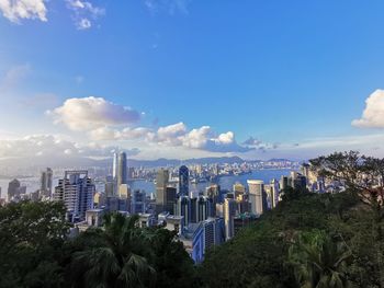 Panoramic view of city buildings against blue sky