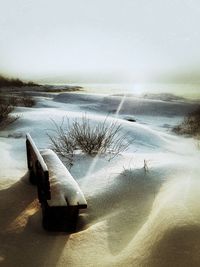 Scenic view of beach against sky during winter
