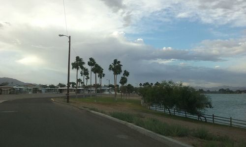 Empty road against cloudy sky