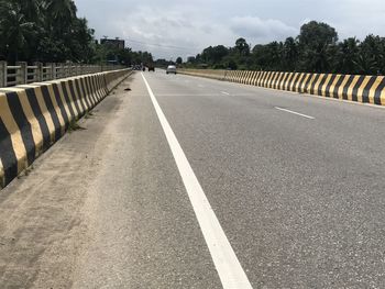 Surface level of road against sky in city