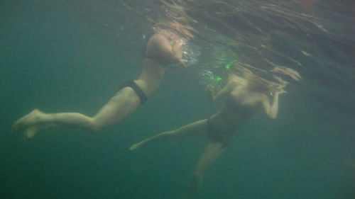 Two women swimming in sea