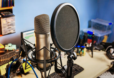 Condenser microphone on home studio,   music sequencer screen background.