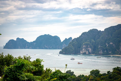 Scenic view of sea and mountains against sky