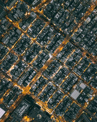 High angle view of illuminated street amidst buildings in city