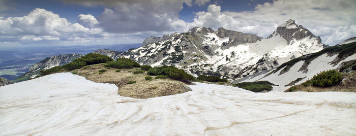 Scenic view of snowcapped mountains against sky