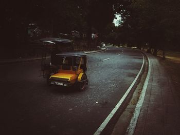 Yellow car on road in city at night