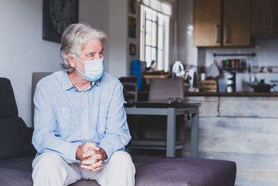Man sitting on sofa at home