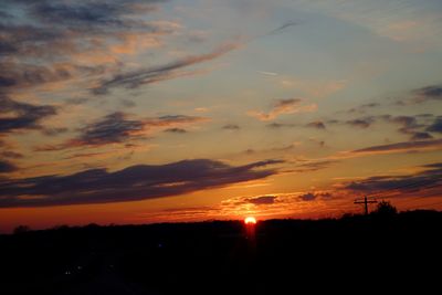 Scenic view of silhouette trees against orange sky