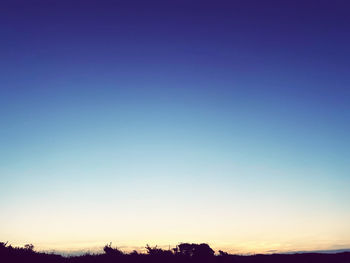 Scenic view of silhouette landscape against clear sky at sunset