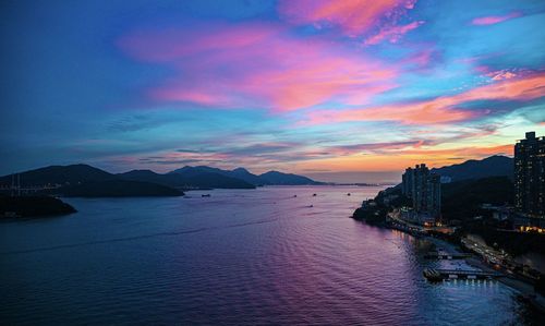 Scenic view of bay against sky at sunset