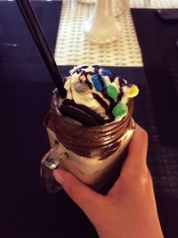 Close-up of hand holding ice cream