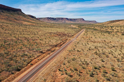 Scenic view of arid landscape against sky