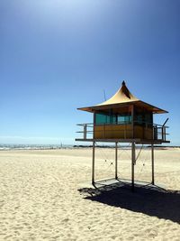 Lifeguard hut on beach against clear sky