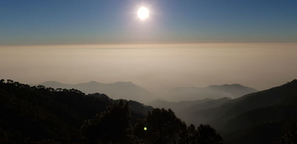 Scenic view of silhouette mountains against sky during sunset