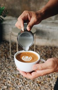 Cropped hand of man holding coffee