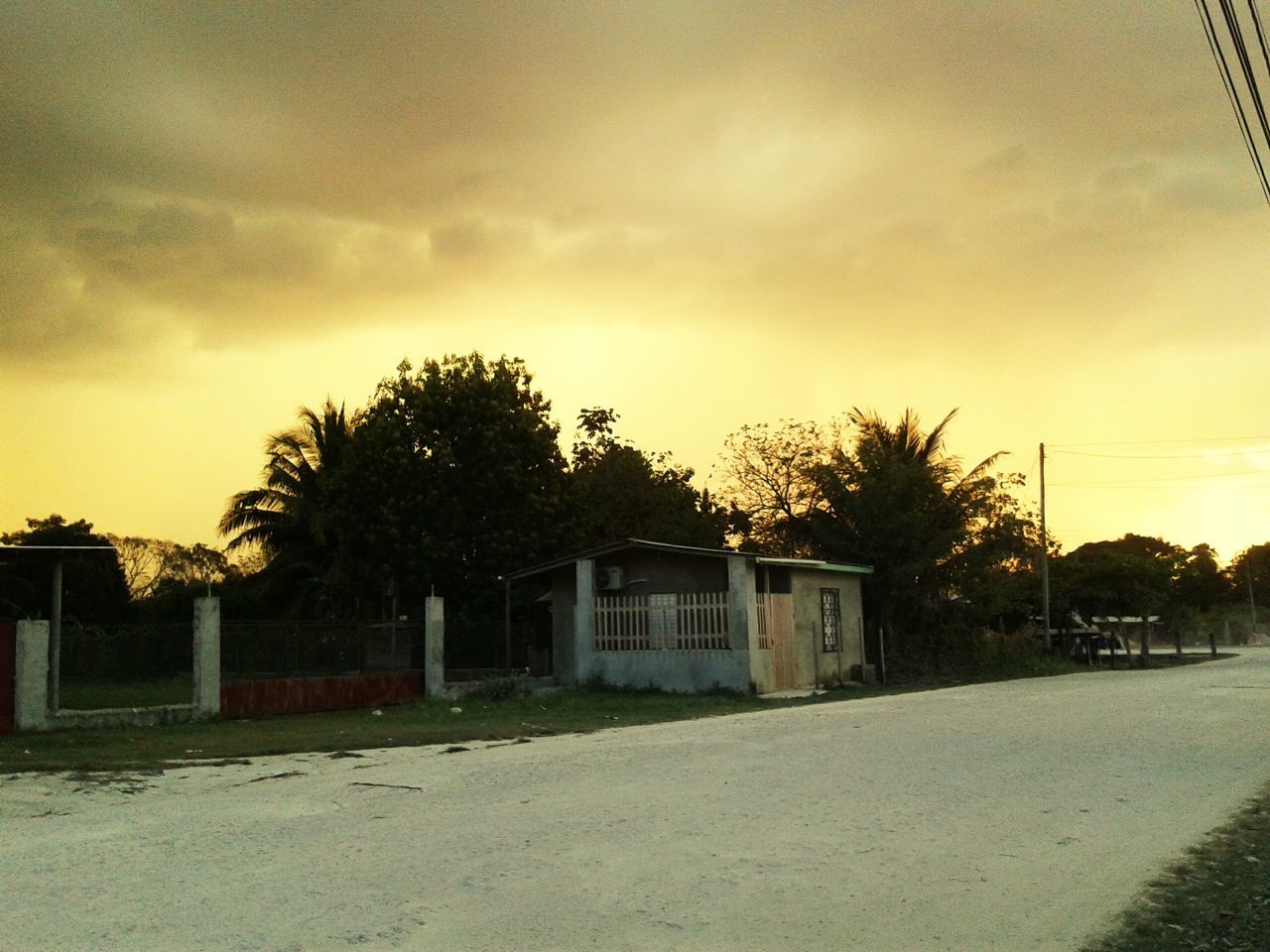 architecture, building exterior, built structure, sky, house, tree, sunset, cloud - sky, residential structure, road, street, residential building, outdoors, no people, cloud, field, nature, cloudy, landscape, tranquility