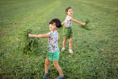 Full length of boy standing on field