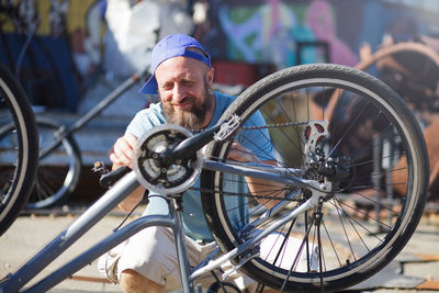 Man working on bicycle wheel