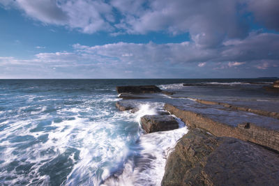 Scenic view of sea against cloudy sky