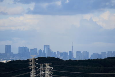 Skyscrapers against cloudy sky