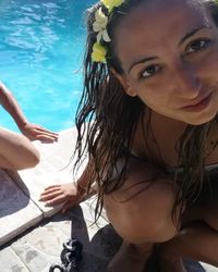 Close-up portrait of young woman in swimming pool