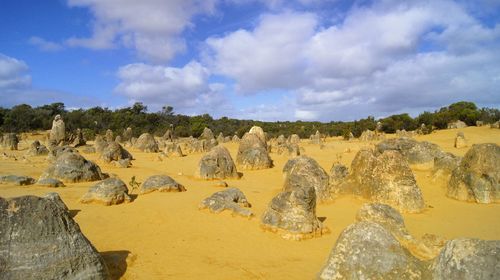 Panoramic view of rock formations against cloudy sky