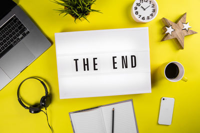 Directly above shot of yellow and laptop on table